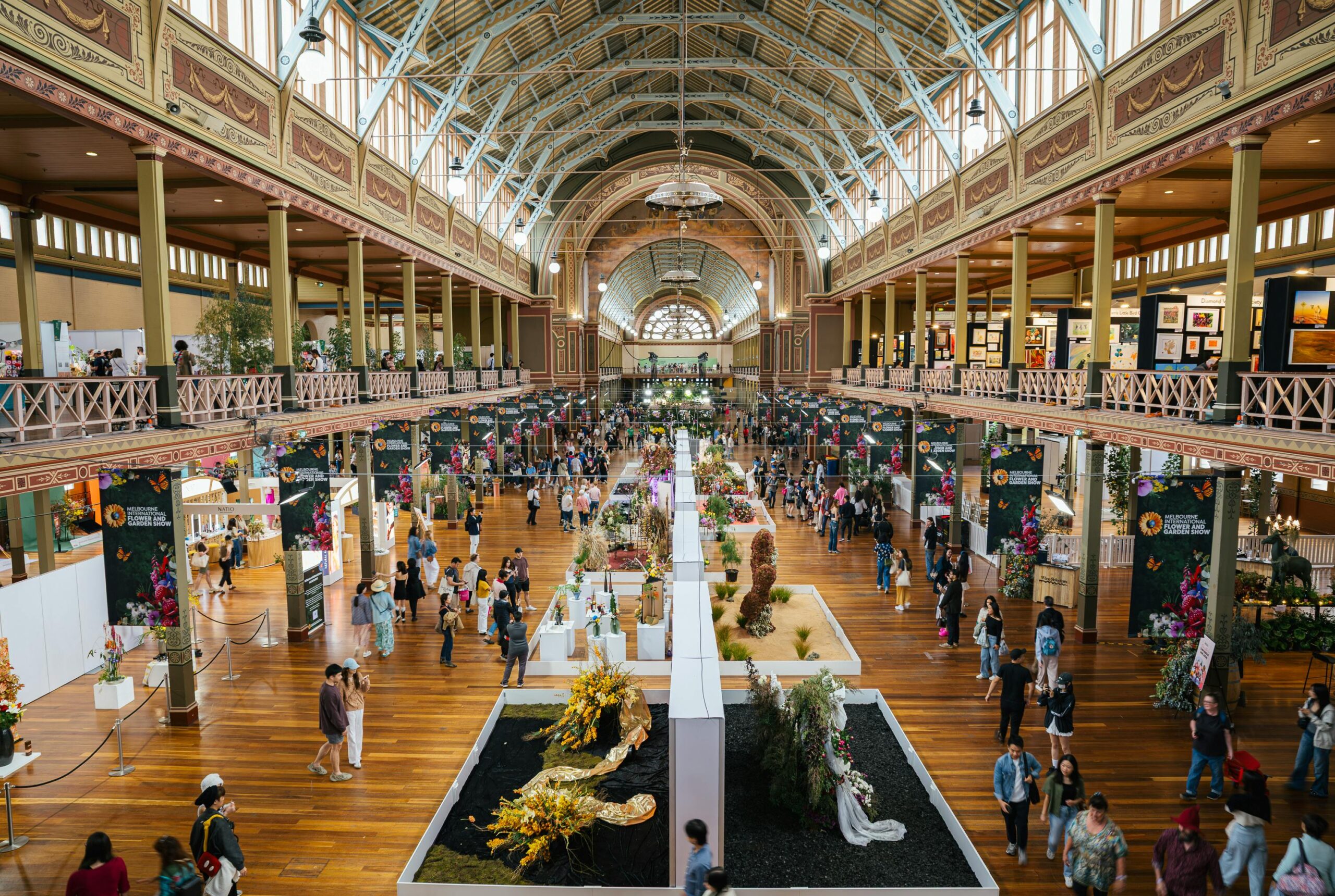 Vibrant event at Carlton's Royal Exhibition Building showcasing diverse art and floral displays.