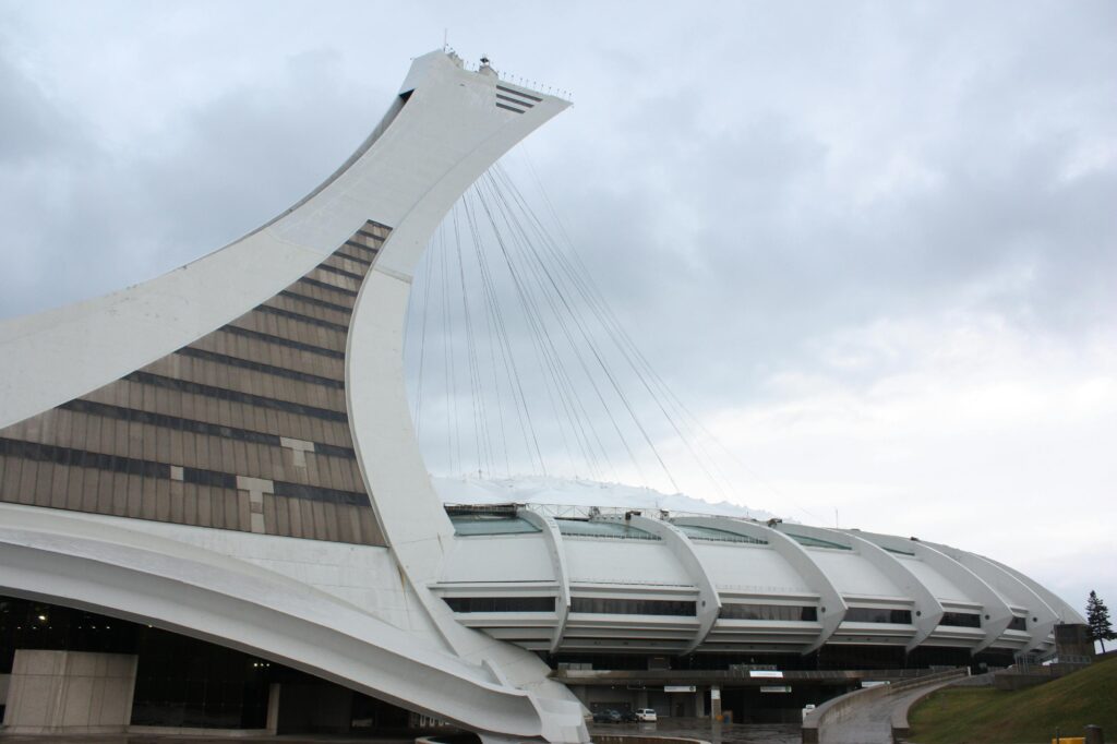 View of the unique architectural design of Montreal's Olympic Stadium under a cloudy sky.