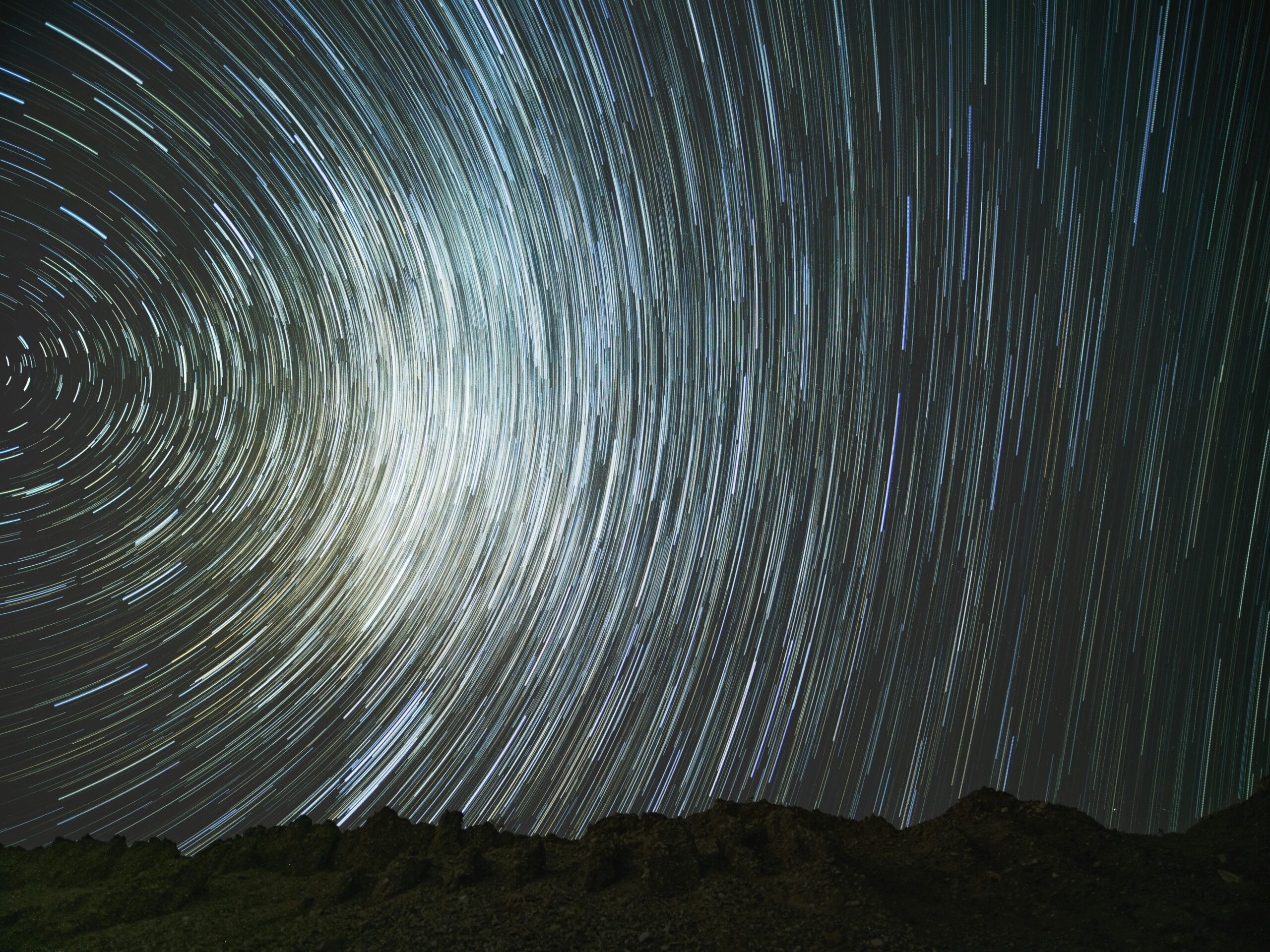 A breathtaking star trail captured over a mountainous landscape in China, showcasing celestial movements.