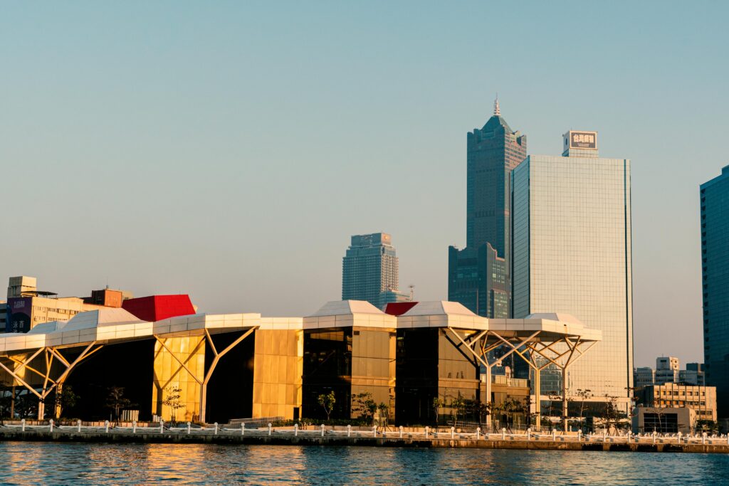 Panoramic view of the Kaohsiung skyline with skyscrapers and riverside at sunset in Taiwan.