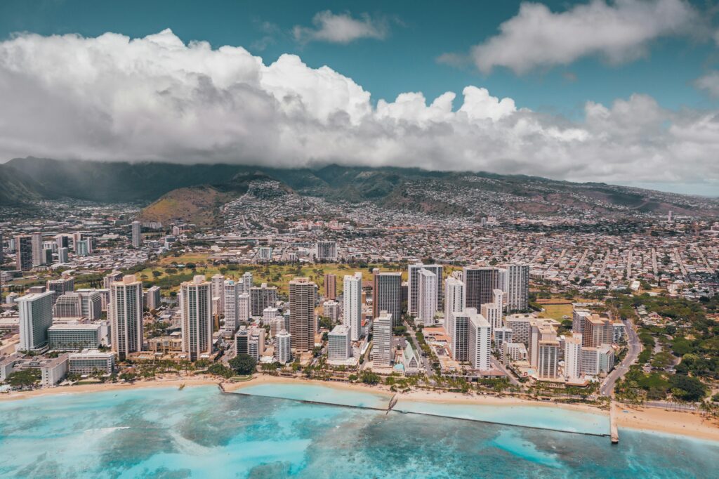 A breathtaking aerial view of Honolulu's cityscape and beach coastline.