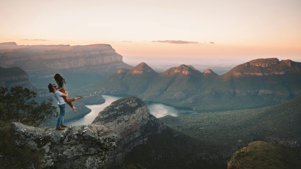 A couple enjoys a breathtaking view of the canyon in South Africa during sunset.