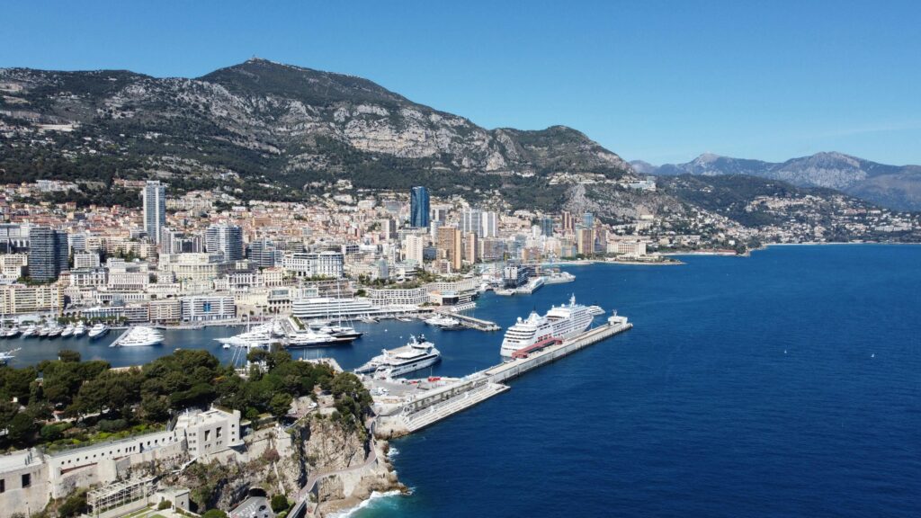 Aerial photograph showcasing Monaco's beautiful coastline, harbor, and cityscape.