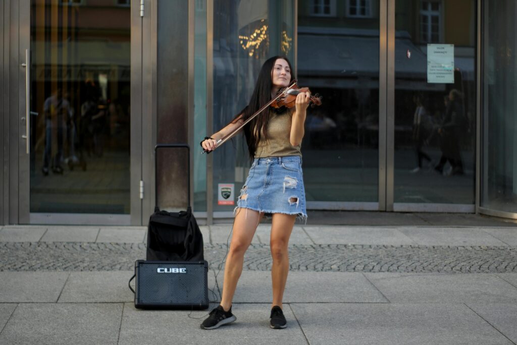 Young woman violinist performing on the street in Wrocław, Poland.