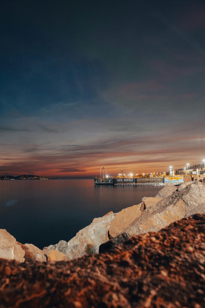Experience the calm İstanbul waterfront with vibrant hues at twilight, showcasing the serene coastline.