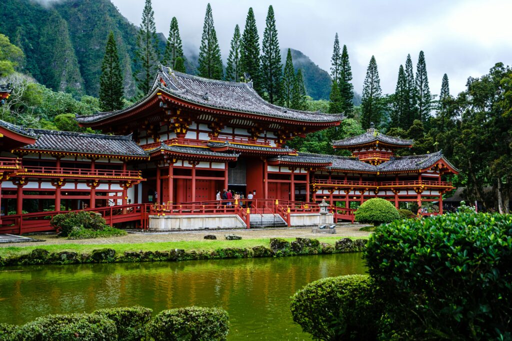 Scenic view of Byodo-In Temple amidst lush greenery in Honolulu, Hawaii, showcasing traditional Japanese architecture.
