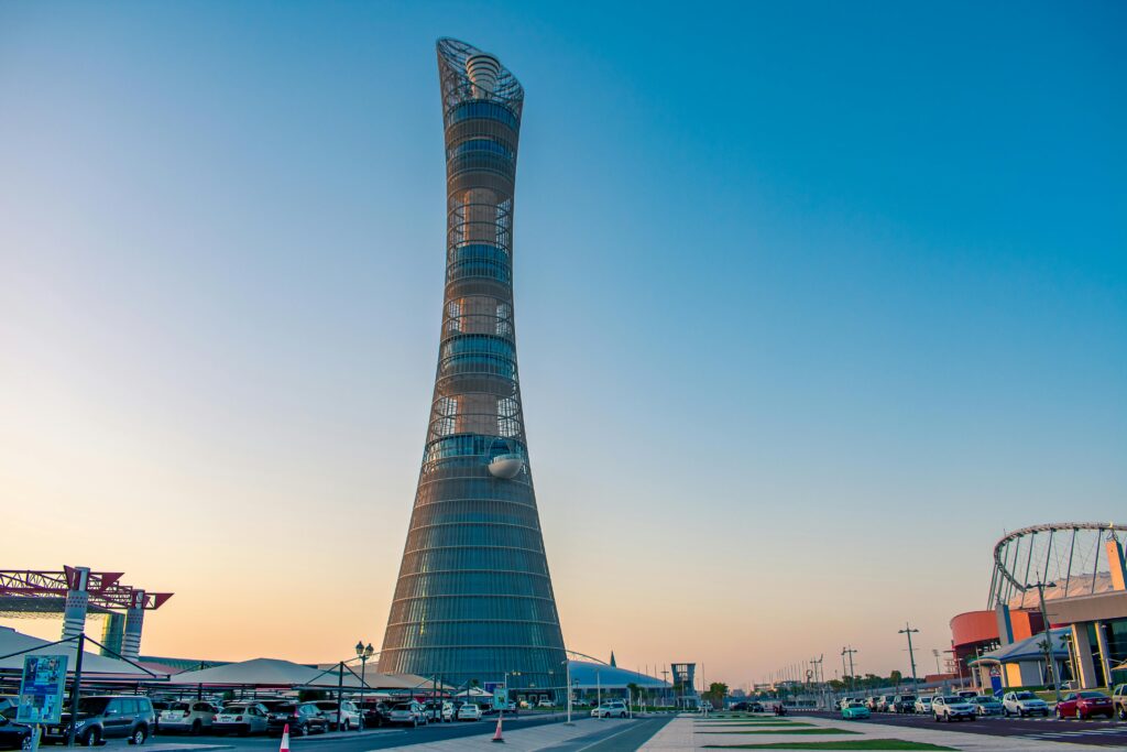 Aspire Tower in Doha stands tall against a clear sky, showcasing modern architecture.
