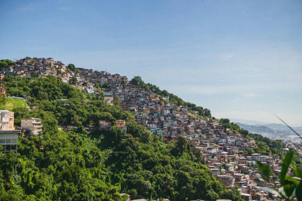 Scenic aerial view of a favela on a lush hillside in Rio de Janeiro, Brazil.