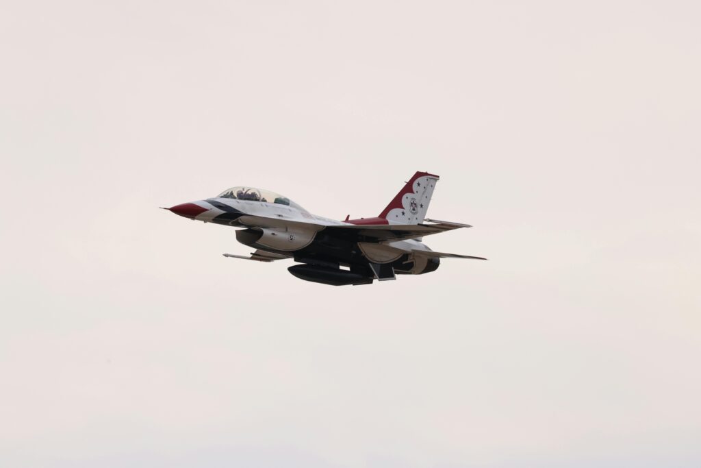 Military jet performing in the sky, showcasing advanced aerodynamics and speed.