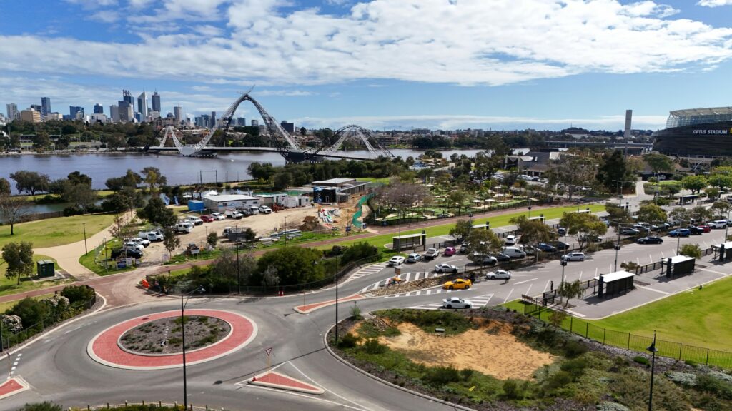 Aerial view of Burswood, WA showcasing Perth city skyline, Matagarup Bridge, and Optus Stadium.