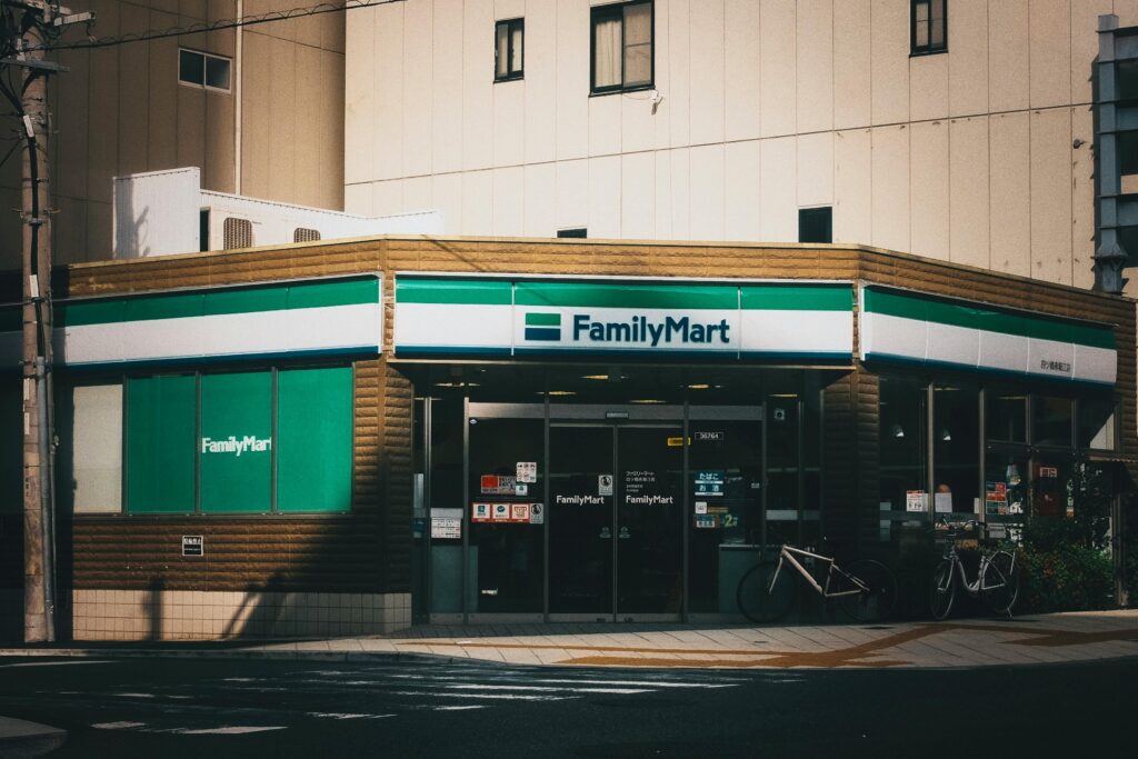 Outdoor view of a FamilyMart convenience store with bicycles parked outside.