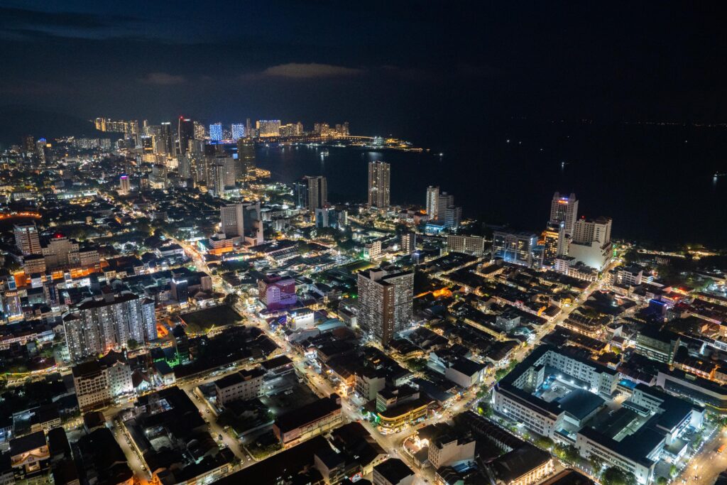 Aerial view showcasing the vibrant urban landscape and skyline of Penang, Malaysia at night.