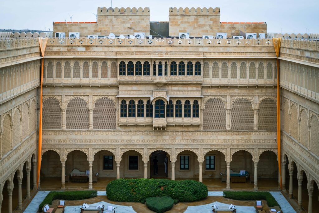 Explore the ornate sandstone architecture of a luxury heritage courtyard in Jaisalmer, Rajasthan.