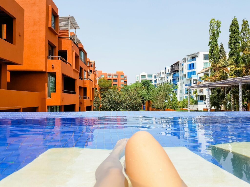 Enjoy a luxurious poolside retreat with a view of modern buildings in Thailand.
