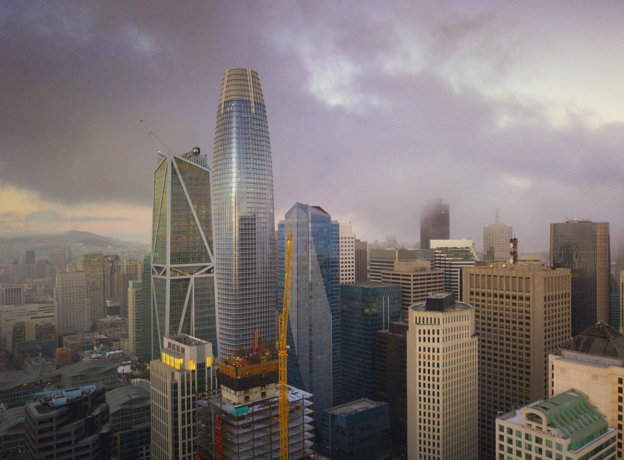Stunning skyline view of San Francisco's skyscrapers enveloped in fog during twilight.