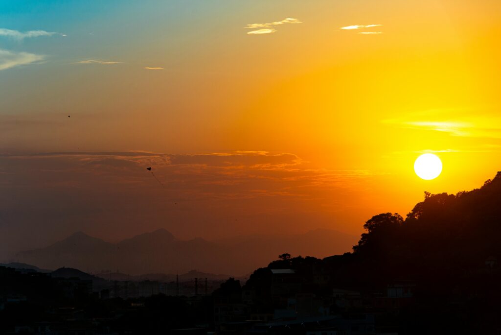 Silhouette of Rio de Janeiro skyline against a vivid sunset sky.