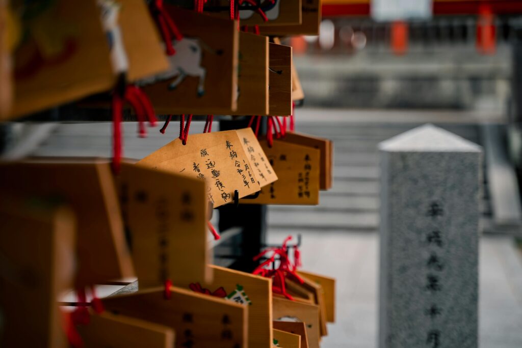 Close-up of ema wooden plaques with wishes in a Kyoto shrine, highlighting Japanese culture.