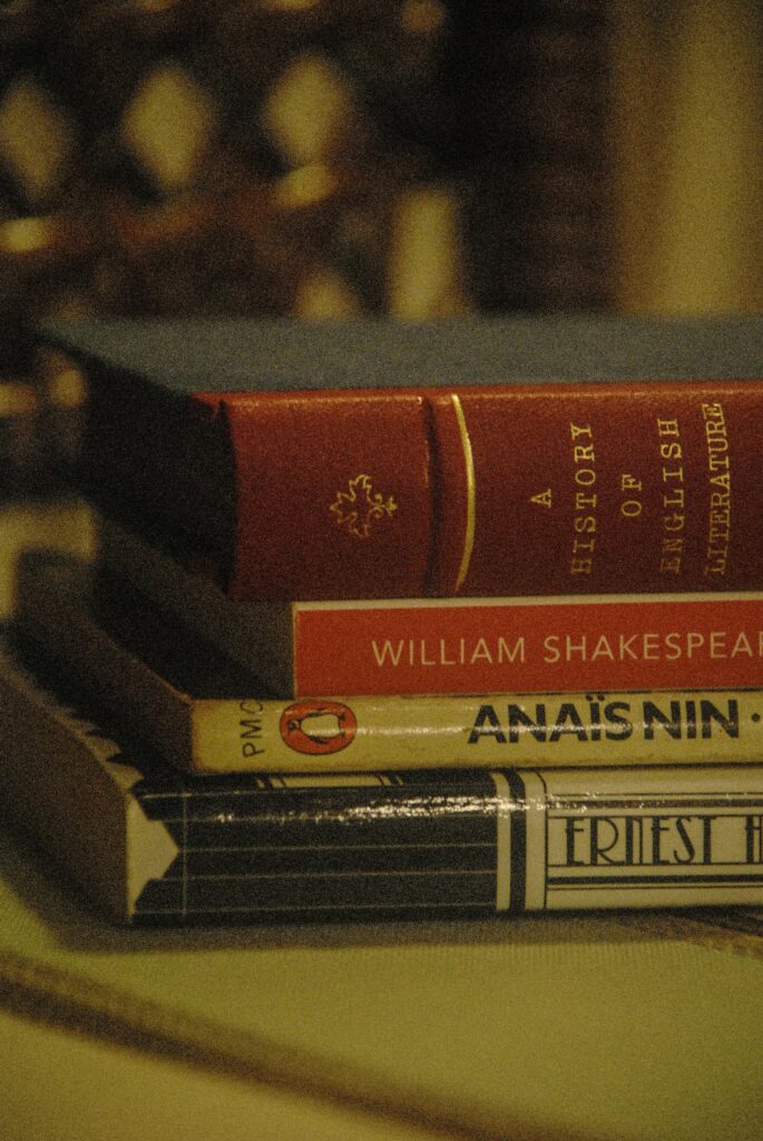 A close-up of a stack of classic literature books including Shakespeare's works.