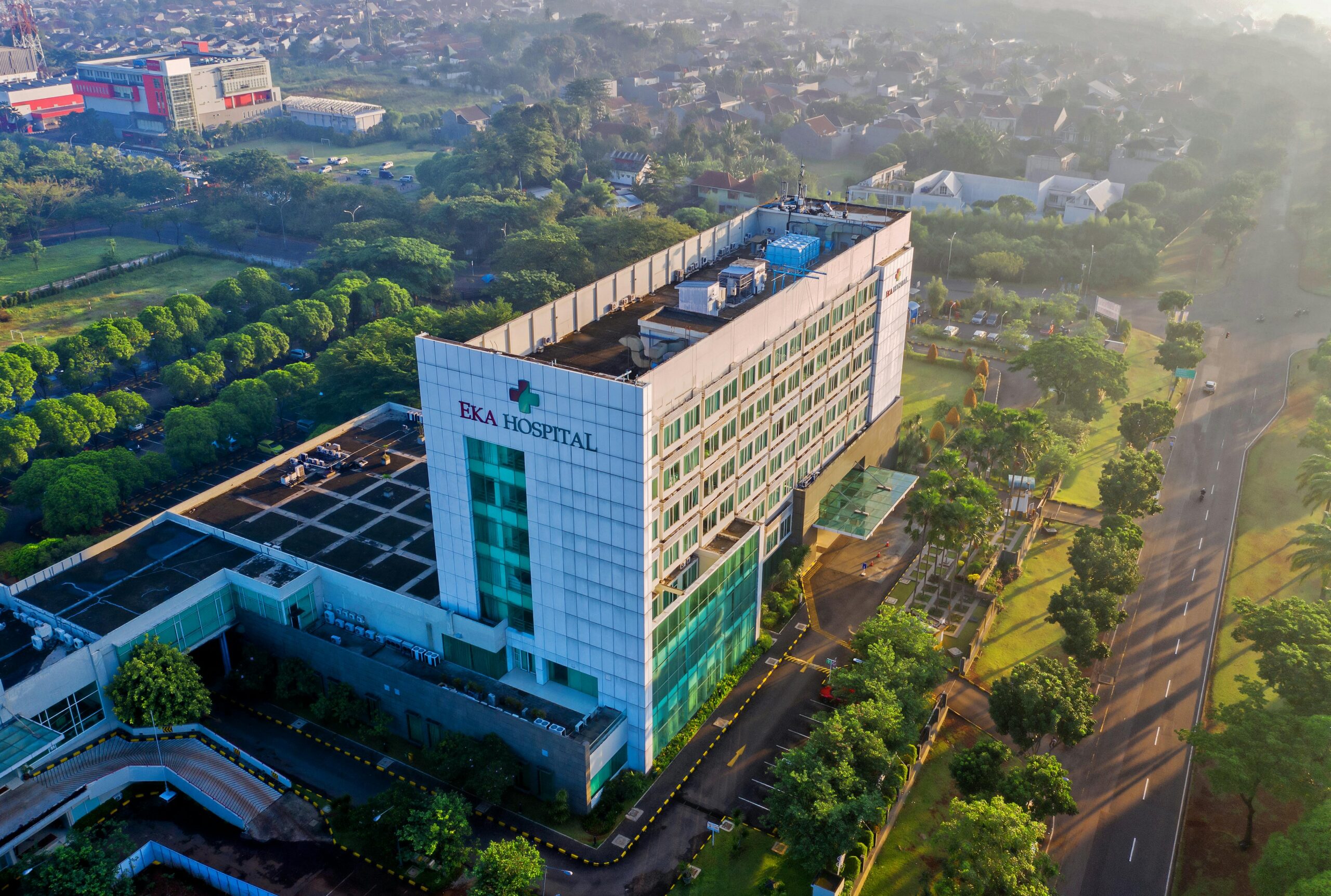 Discover the contemporary architecture of Eka Hospital from an aerial perspective, surrounded by lush greenery in Serpong, Indonesia.