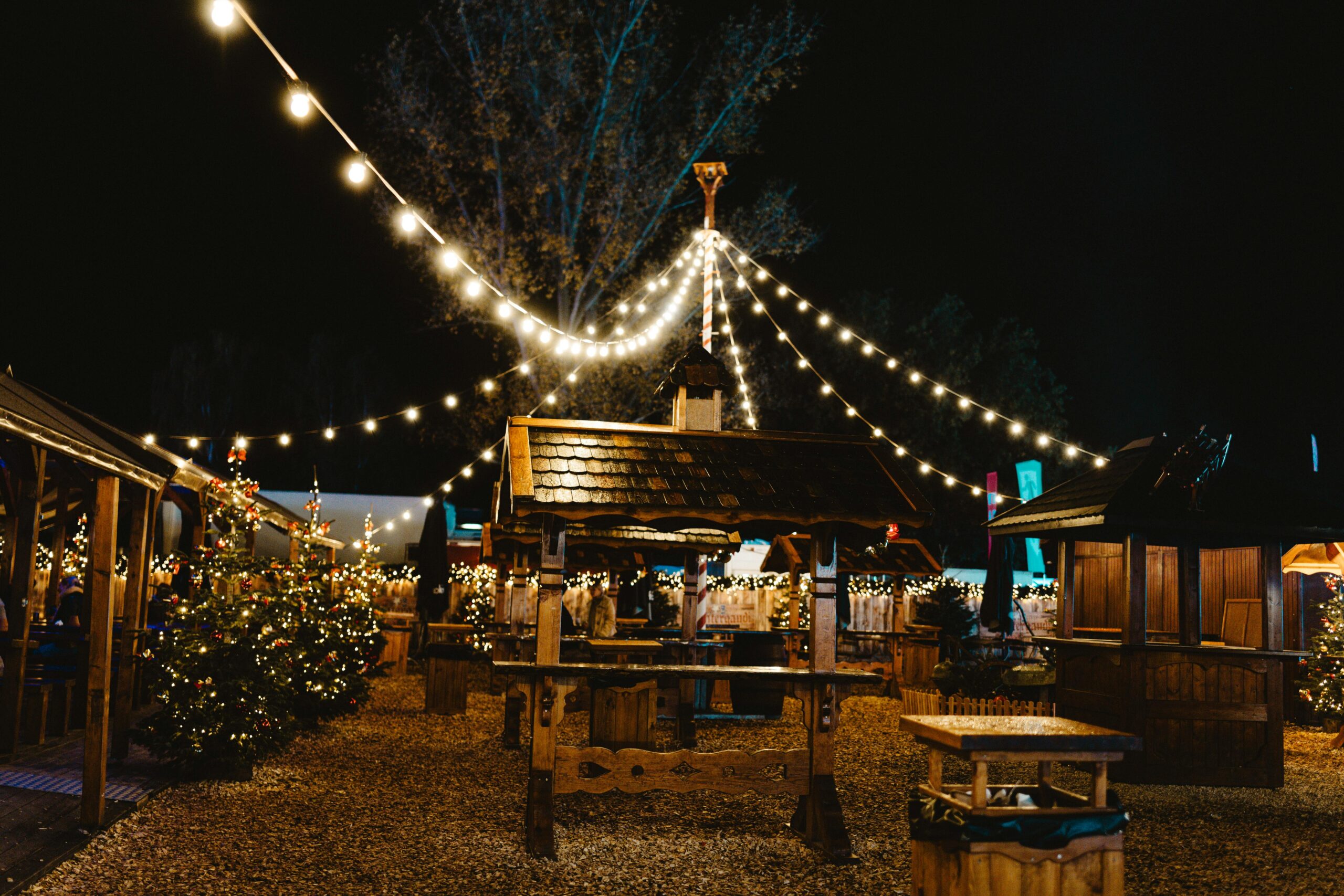 Enchanting Berlin Christmas market illuminated at night with festive decorations and lights.
