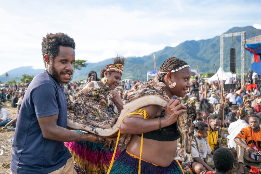A vibrant cultural celebration in Papua New Guinea featuring traditional attire and performances.
