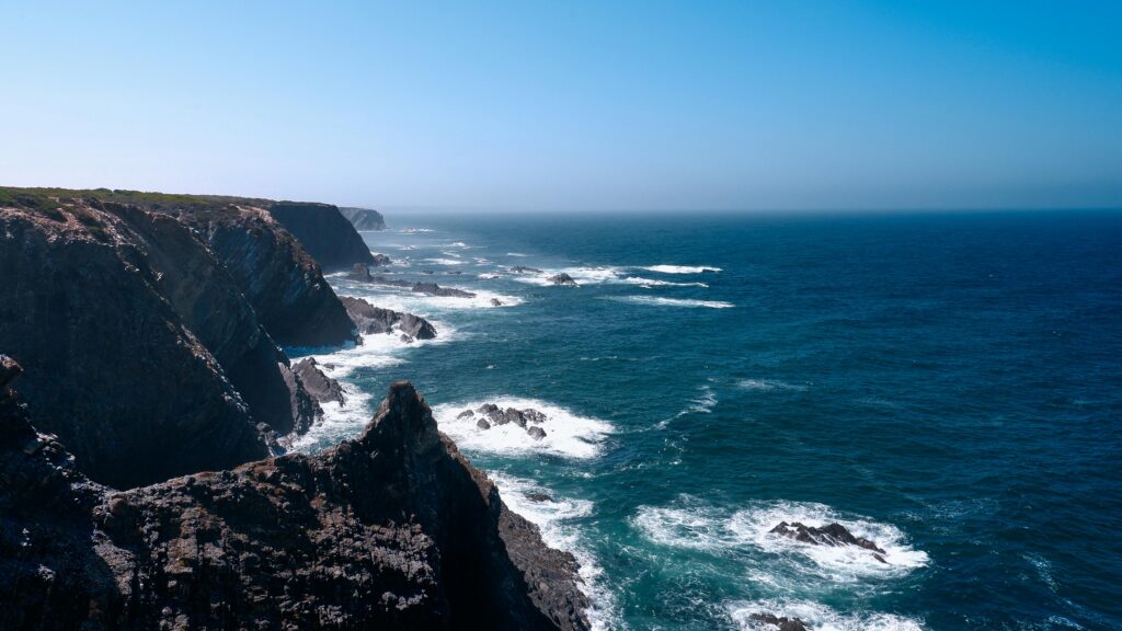 Majestic cliffs overlooking the deep blue Atlantic Ocean in Beja District, Portugal.