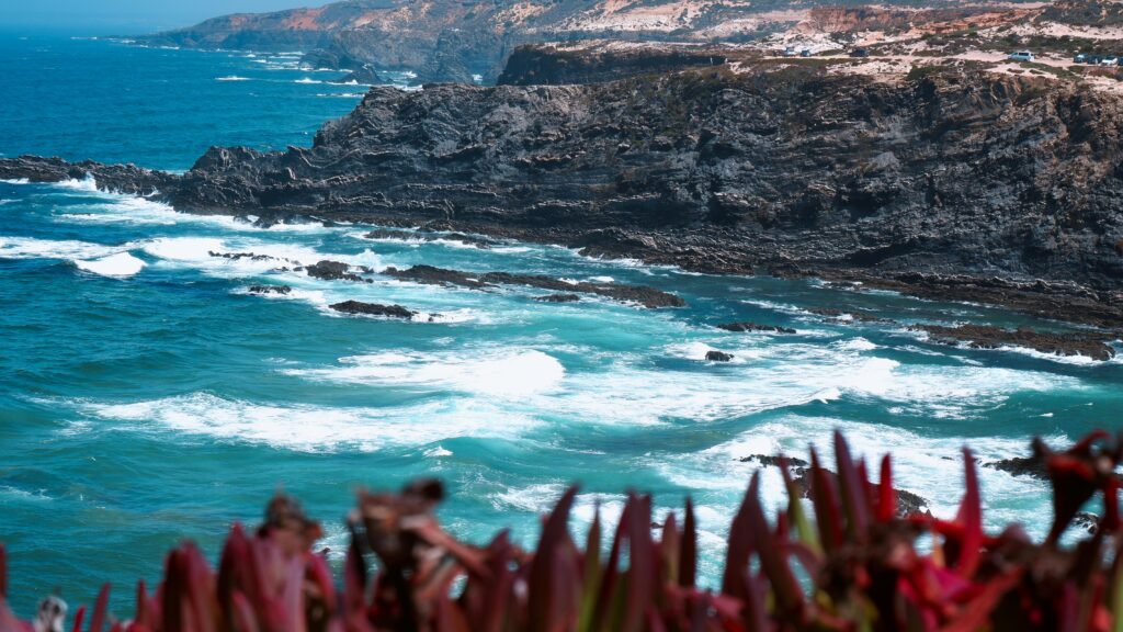 Stunning view of rugged cliffs and crashing waves in southern Portugal's Beja District.