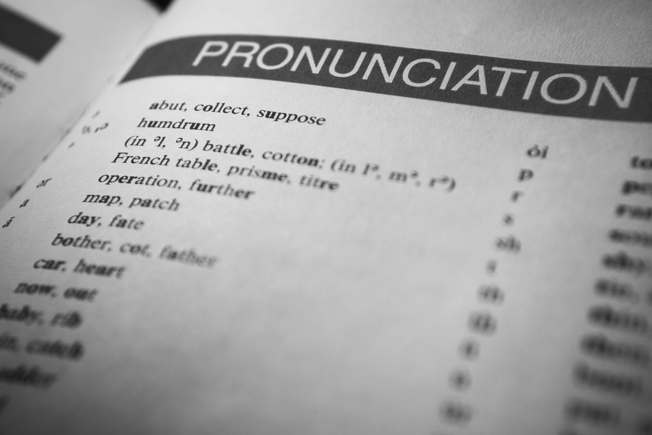 Black and white close-up of a dictionary page focused on pronunciation guides and phonetic symbols.