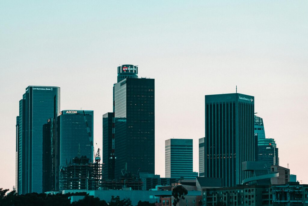 Explore the iconic skyline of downtown Los Angeles with its towering skyscrapers against a clear sky.