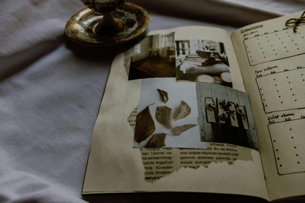 A vintage scrapbook featuring artistic photographs and journal entries, evoking nostalgia.