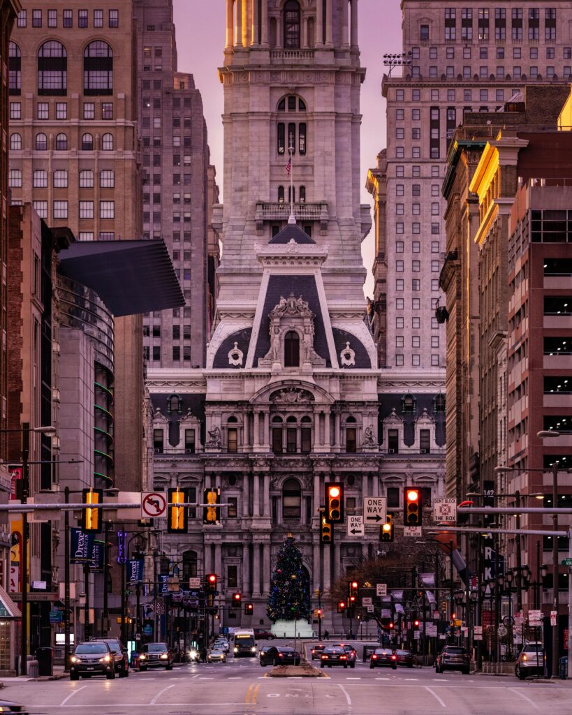 Stunning view of Philadelphia City Hall adorned with Christmas lights in winter evening.