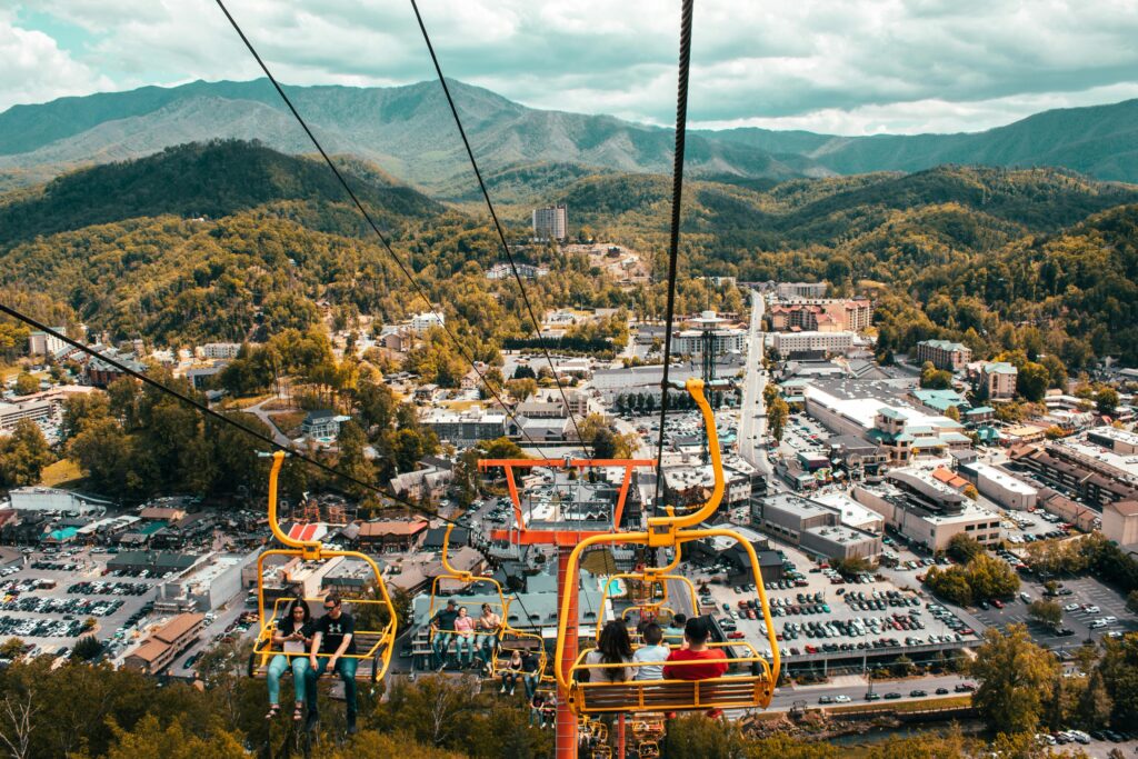Aerial view of Pigeon Forge, TN from a ski lift, showcasing the vibrant cityscape and Smoky Mountains.