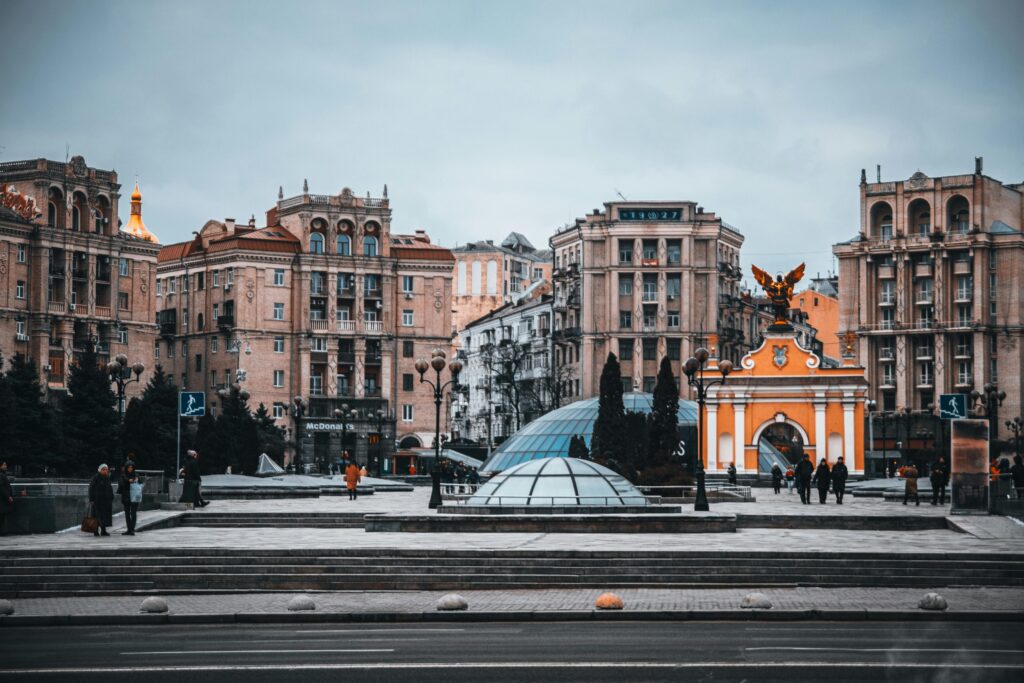 Majestic view of Kyiv's Independence Square showcasing historic architecture and vibrant urban life.