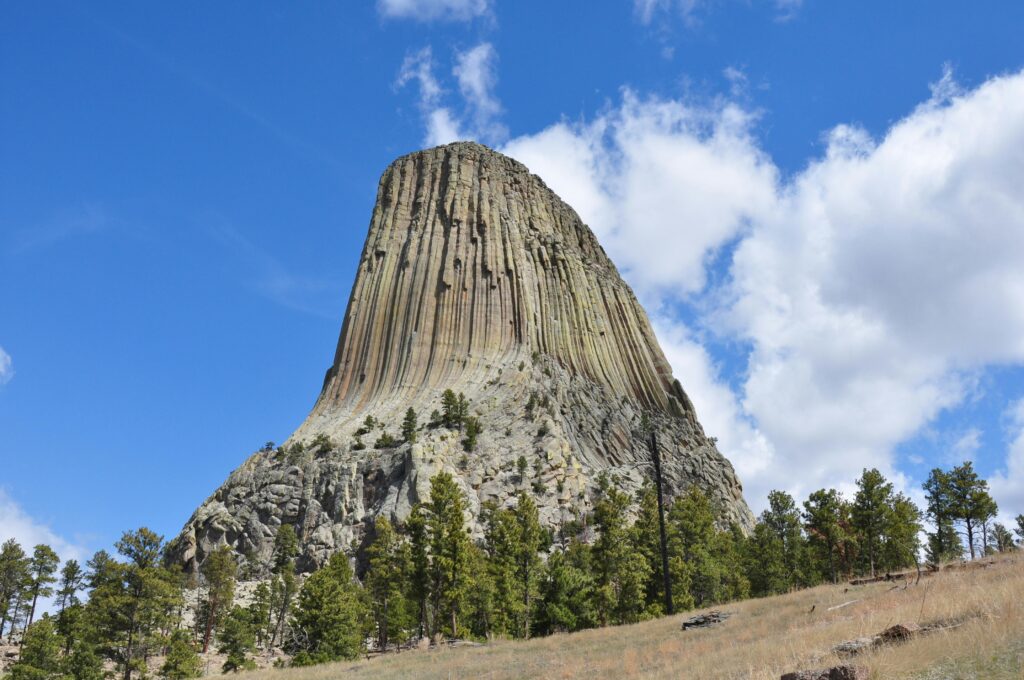 Stunning landscape of Devils Tower, Wyoming, USA with clear skies and rocky formations.
