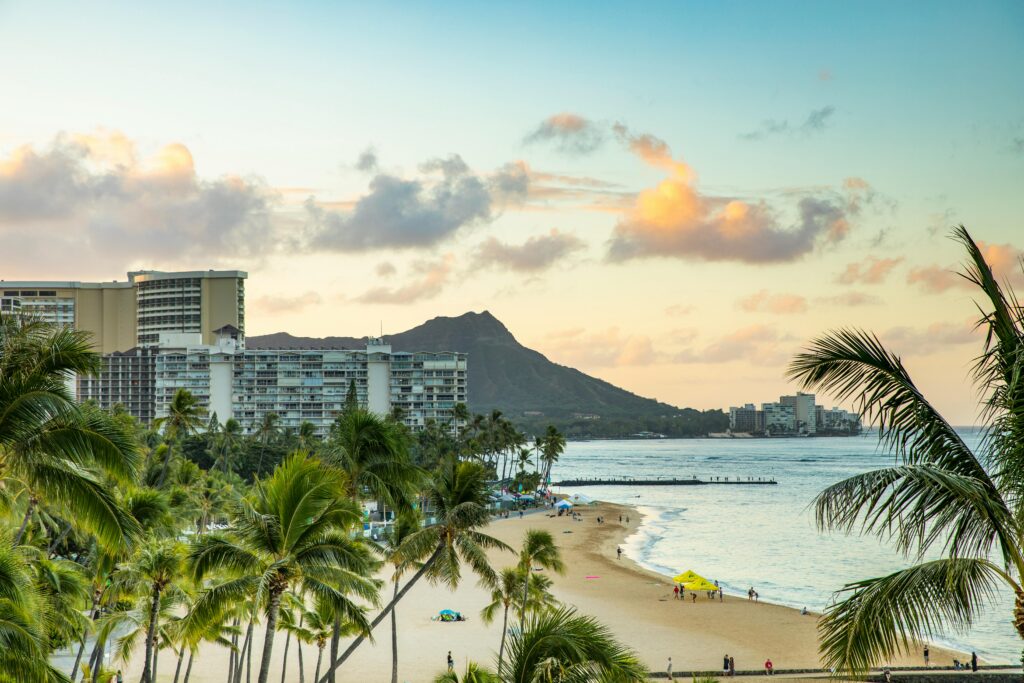 A serene view of Waikiki Beach and iconic Diamond Head at sunset, perfect for travel inspiration.