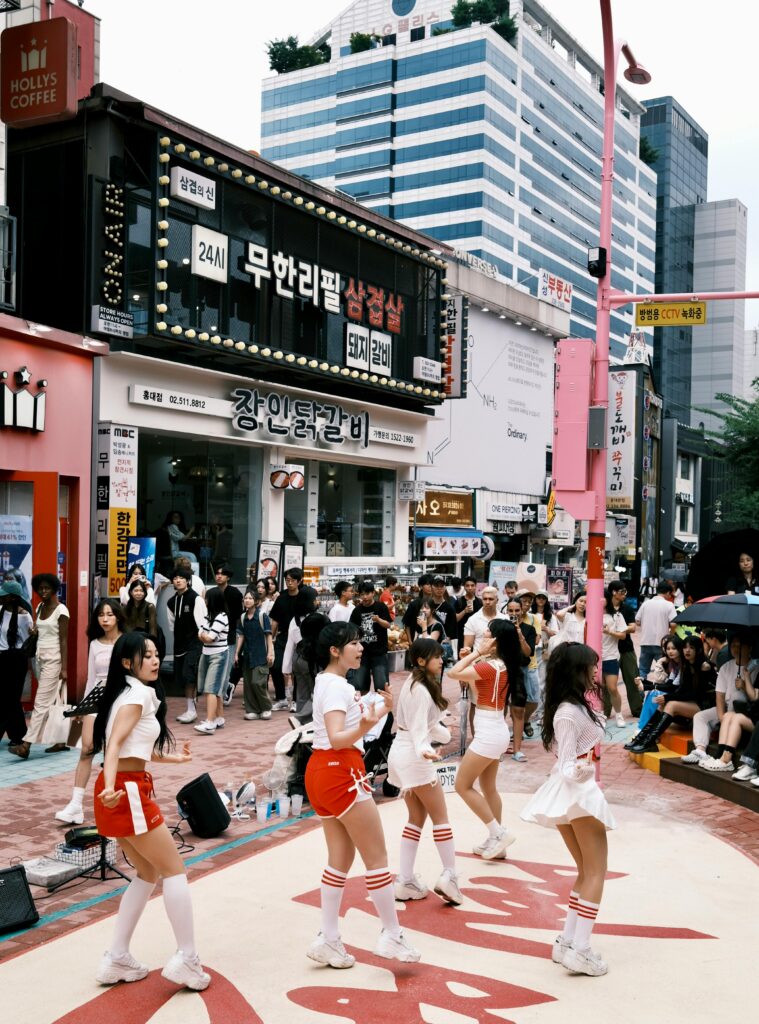 Vibrant street dance performance attracting a lively crowd in Seoul, South Korea.