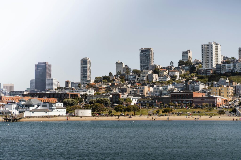A scenic view of San Francisco's coastal skyline with beachfront and urban landscape.