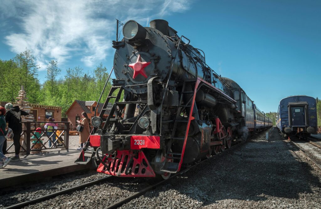 Classic steam train at a station in Sortavala, Russia, showcasing vintage transportation charm.