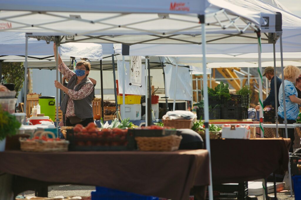 Lively farmers market in Bellingham, WA with vendors and fresh produce.