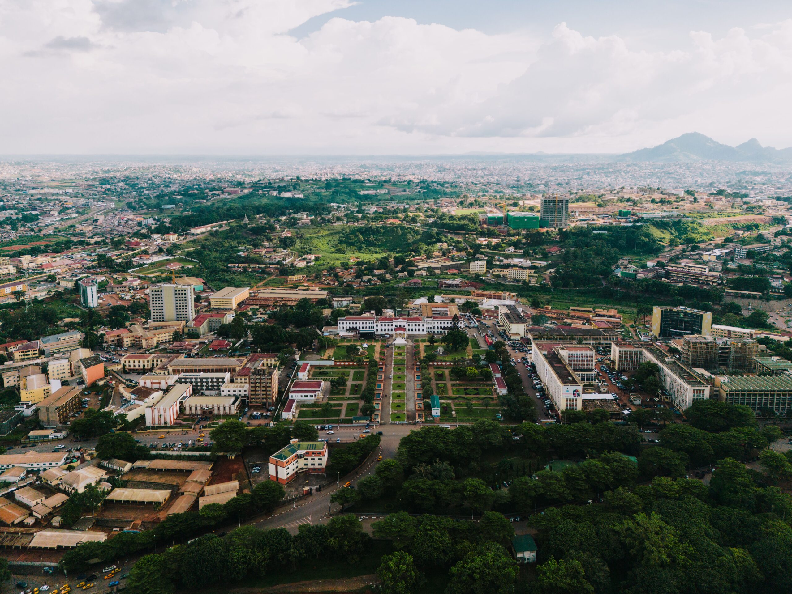 Stunning aerial view of Yaoundé cityscape with green landscapes and urban architecture.