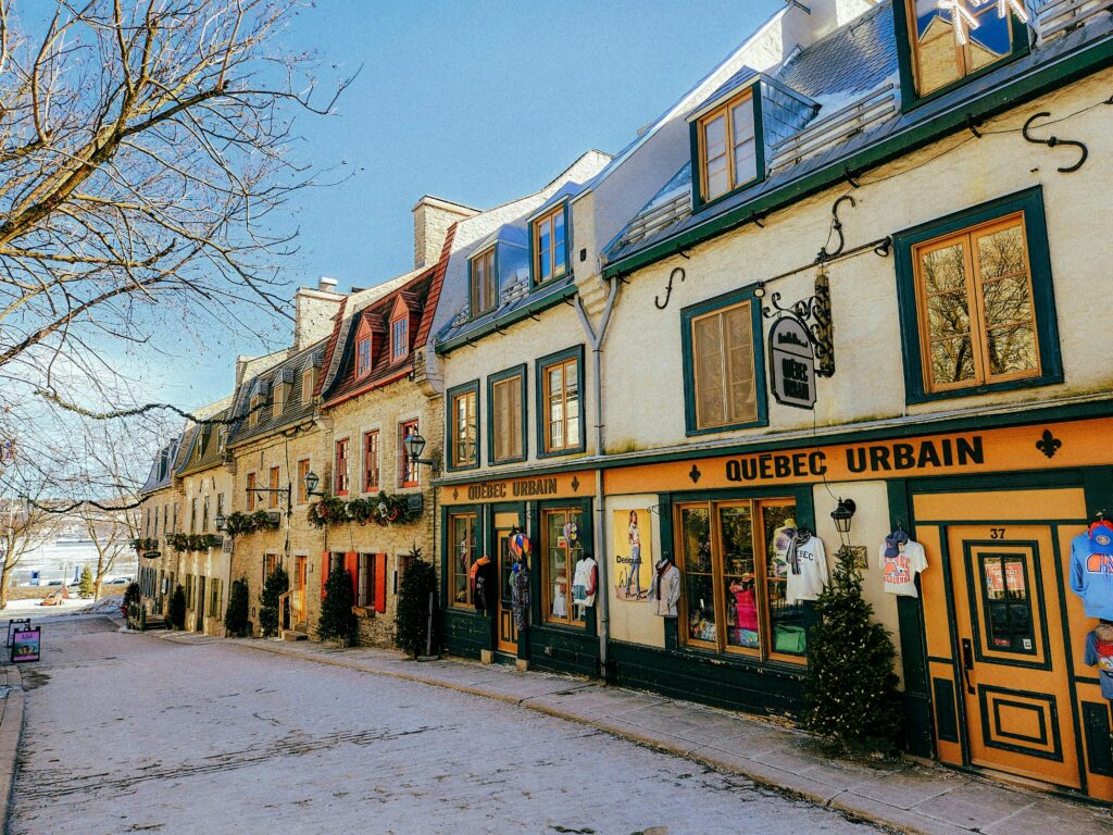 Picturesque winter scene of historic Rue du Petit-Champlain in Quebec City, showcasing colorful colonial-style architecture.