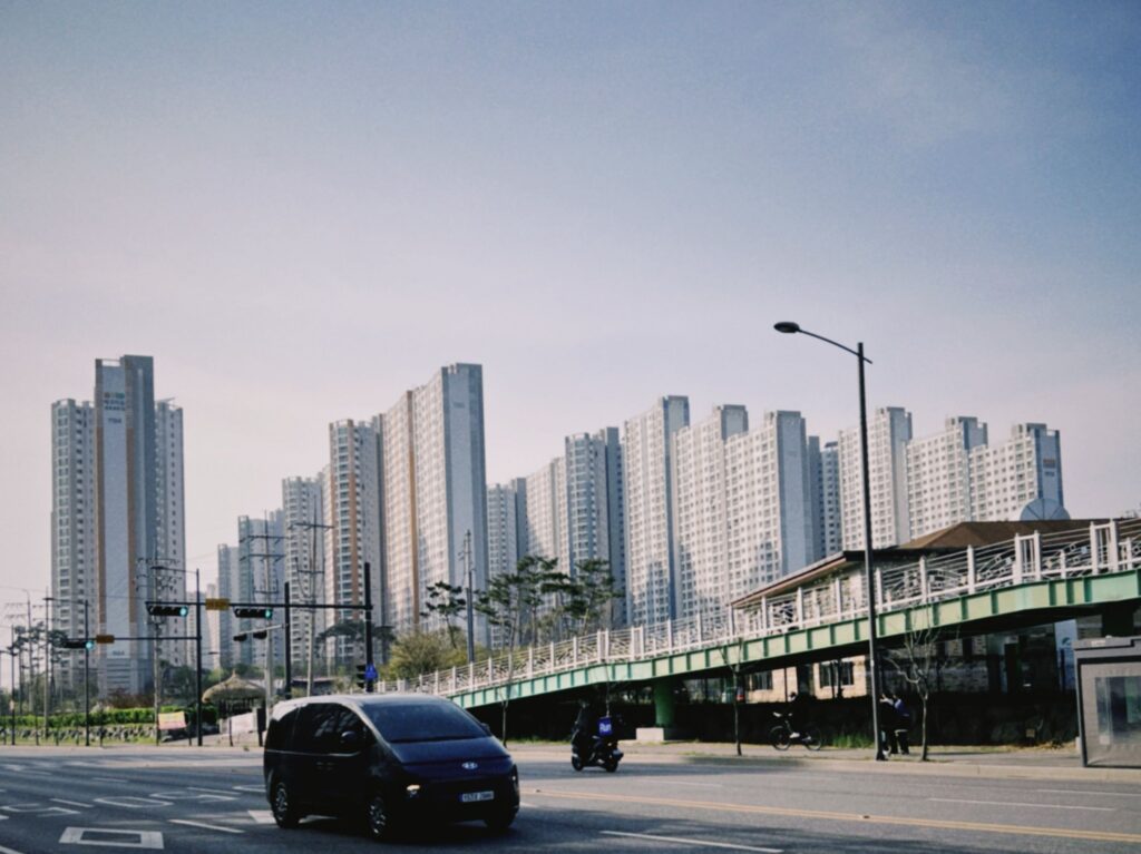 Urban cityscape of Ansan-si skyscrapers and traffic on a sunny day.