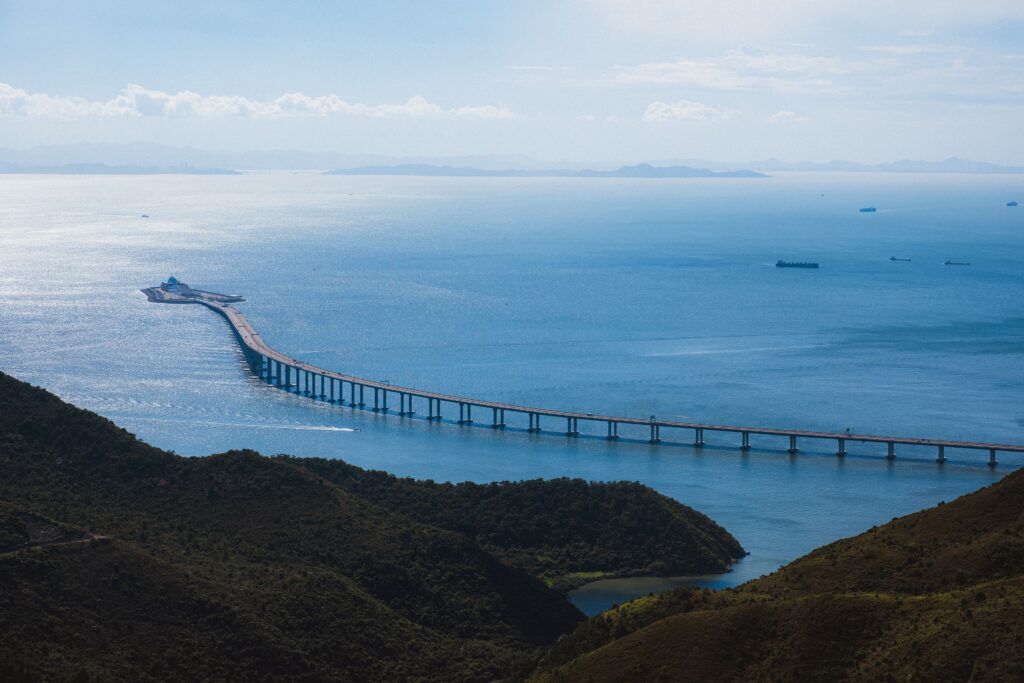 Scenic aerial view of the Hong Kong-Zhuhai-Macau Bridge spanning over tranquil waters.