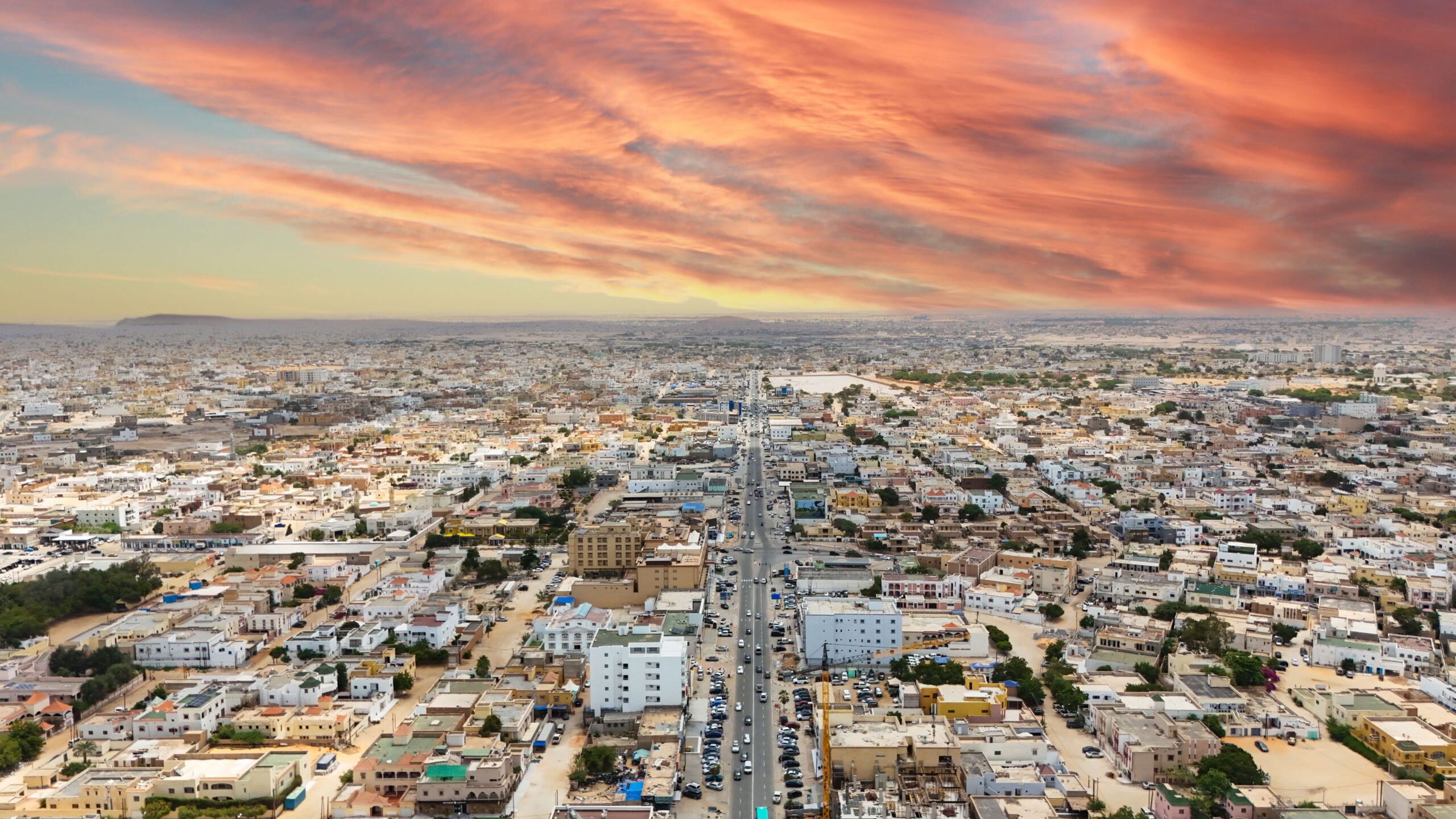 Stunning aerial view of Nouakchott, Mauritania, with vibrant sunset skies and expansive urban landscape.