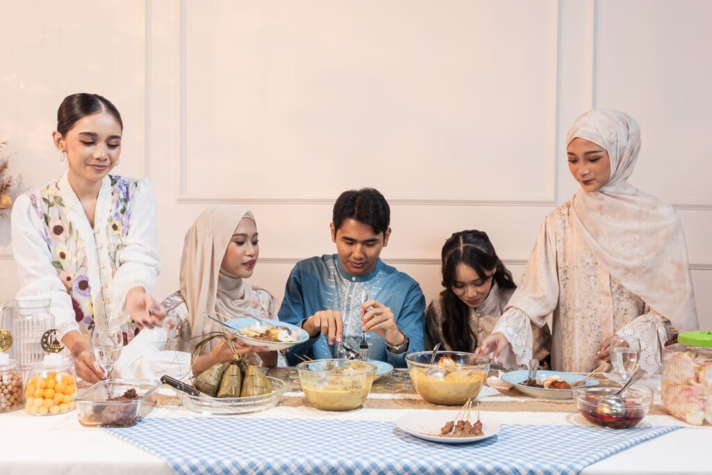 A family enjoying a traditional meal together, celebrating Eid in Jakarta, Indonesia.