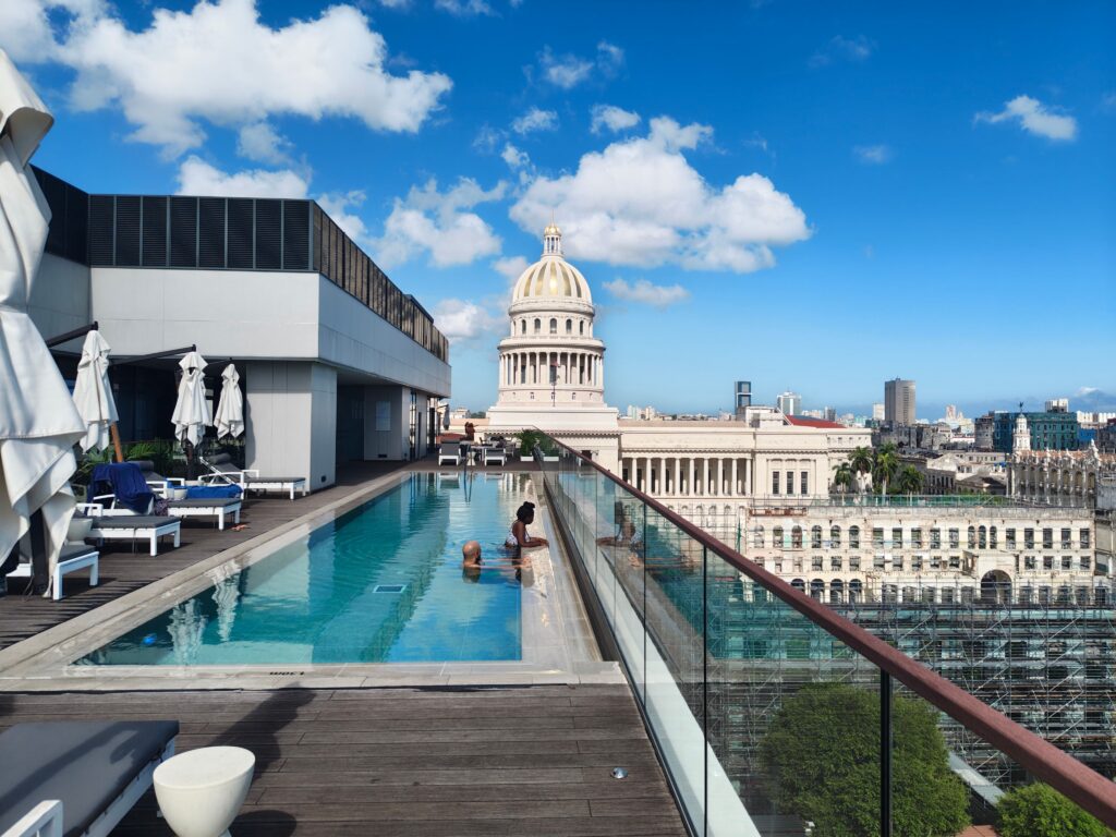 Rooftop pool overlooking Havana's Capitol Building on a sunny day.