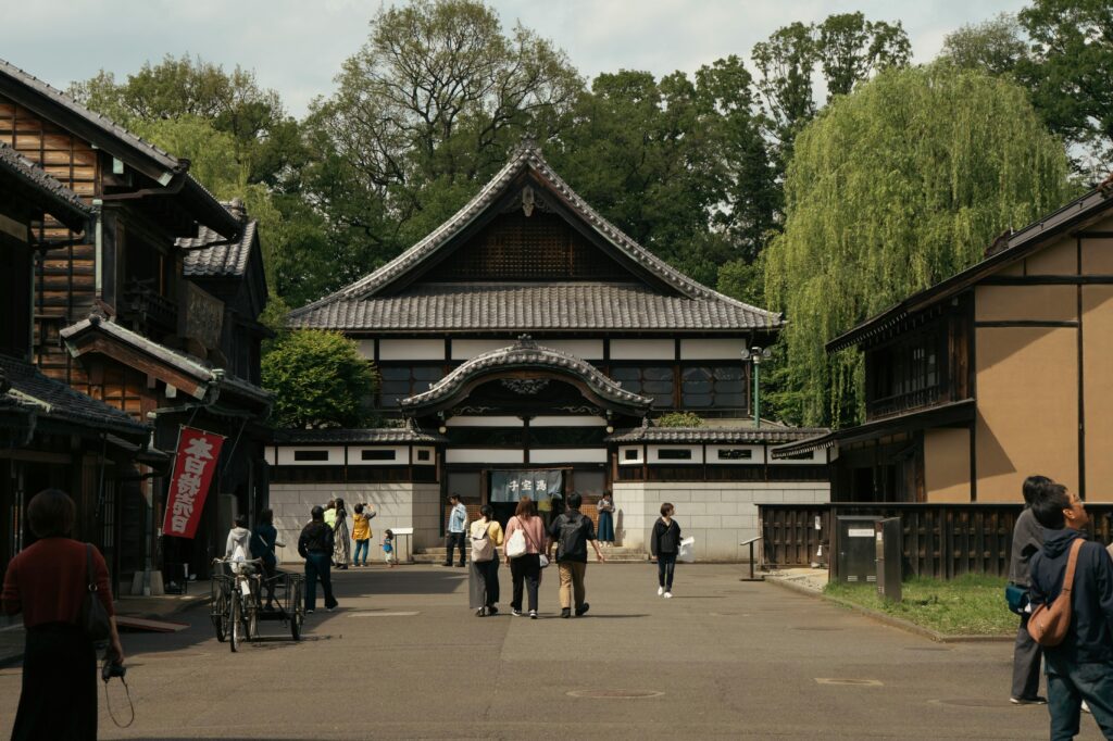 Visitors explore traditional architecture in a serene Tokyo setting.