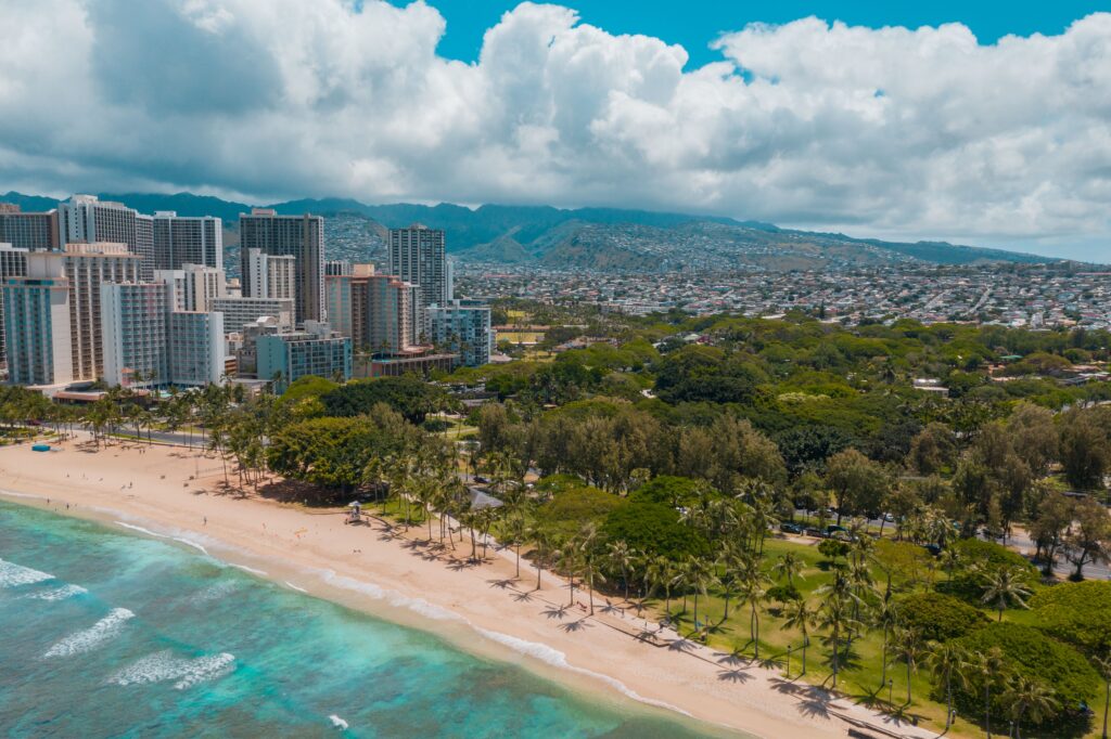 Stunning aerial view of Waikiki Beach with the skyscrapers of Honolulu in the backdrop.