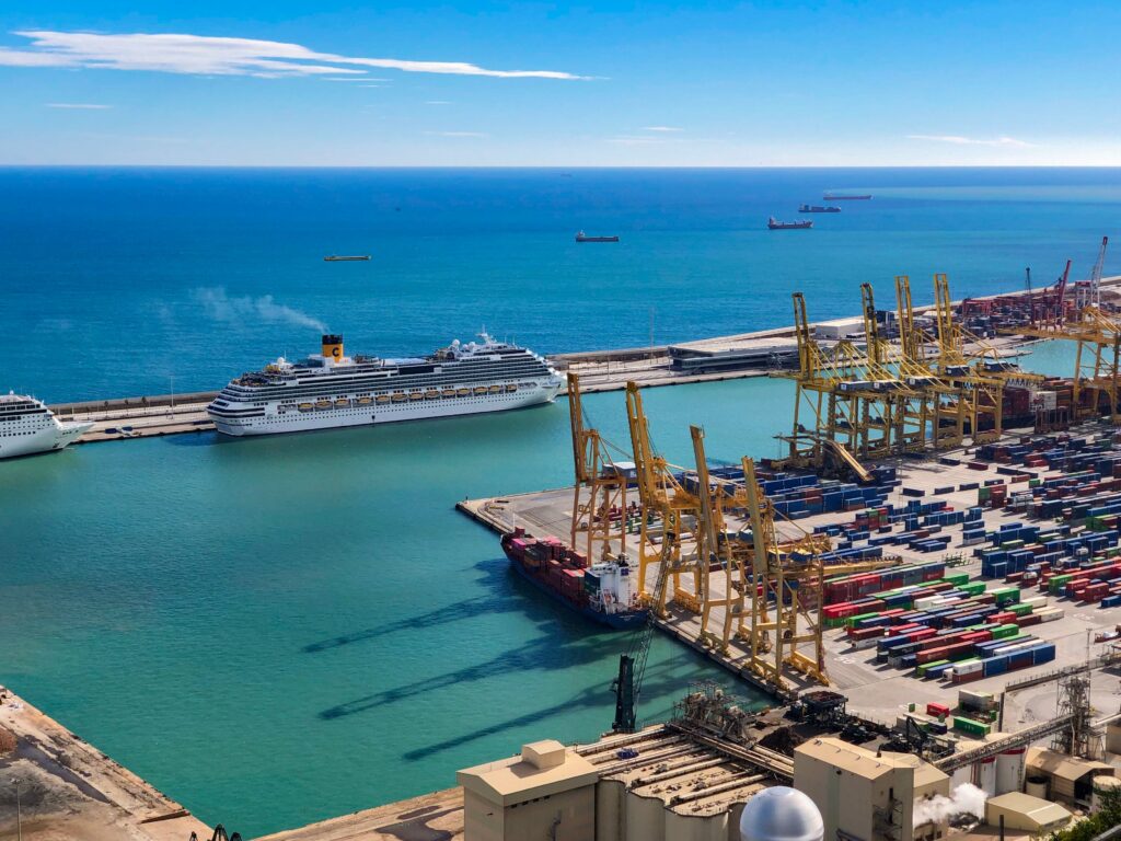 Scenic view of sunny port in exotic city with moored modern huge cruise ships against endless calm sea