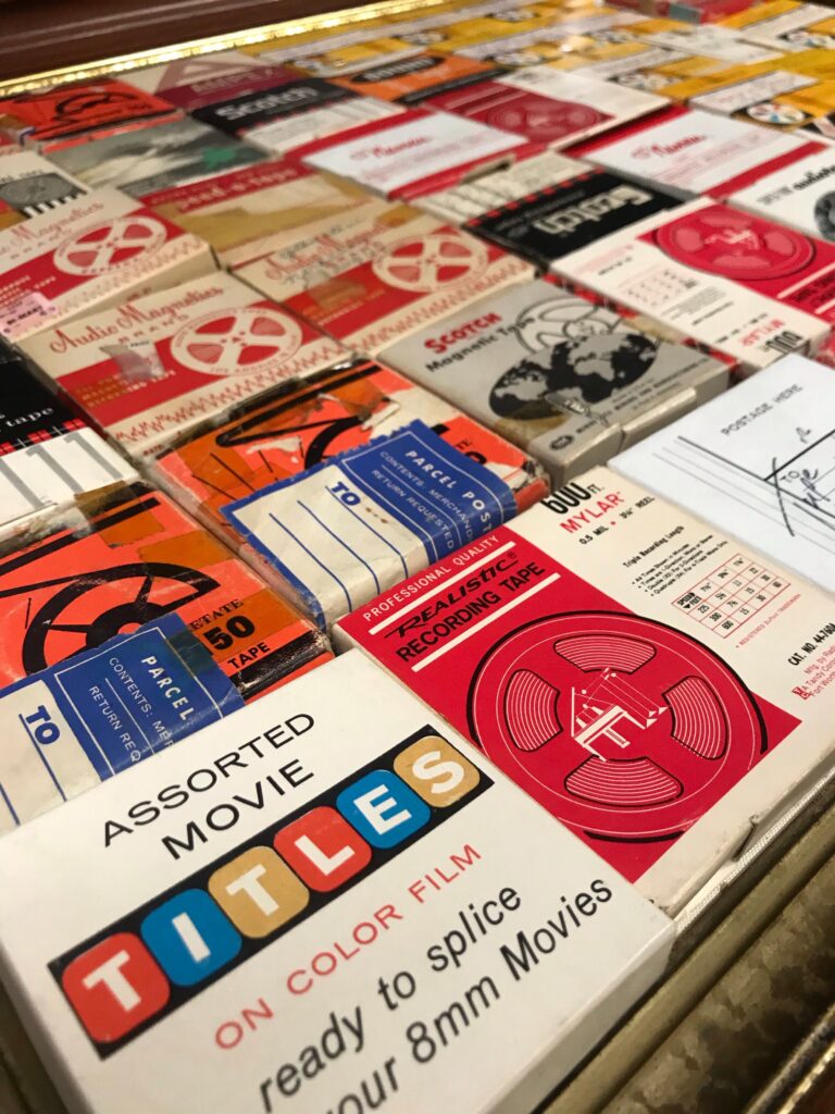 A nostalgic collection of assorted movie tapes and vintage recording media on display.